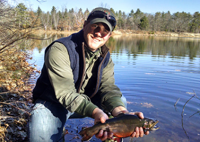Jon Peterson, Maine Guide, showing off a fish