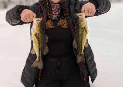 Maine ice fisherwoman showing off her catch
