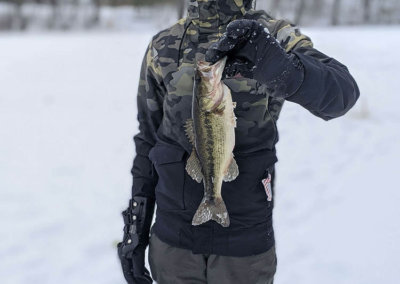 Young Maine ice fisherman showing off catch