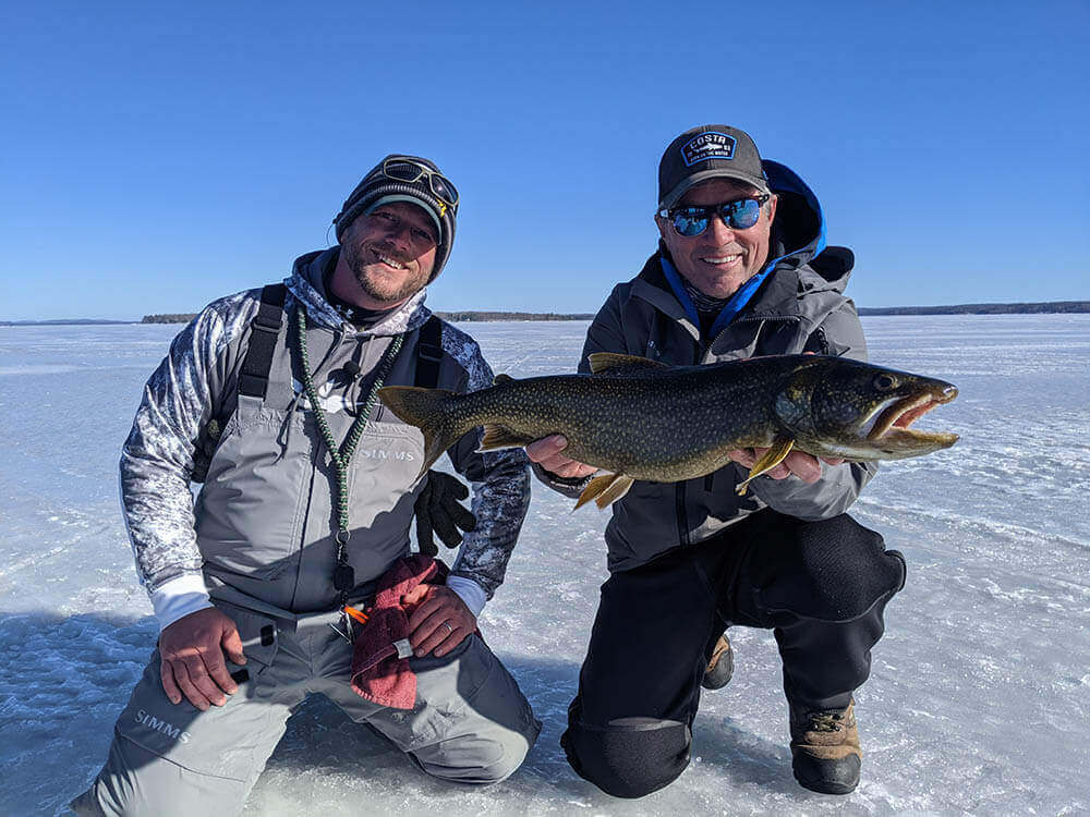 Jon Peterson and client on a Maine Ice Fishing trip