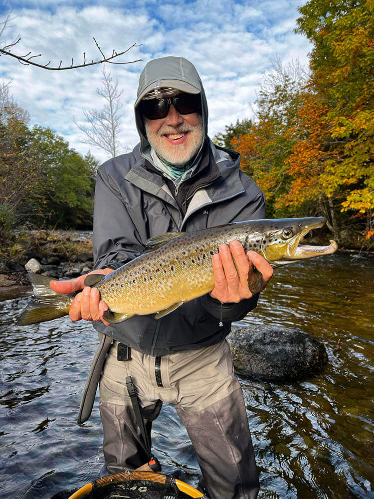 A man holding a fish he caught on the Weatherby Lodge trip