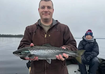 A happy fisherman and son after a day on Sebago lake fishing