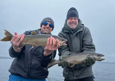 Two happy fishermen showing off their catch after a day on Sebago lake