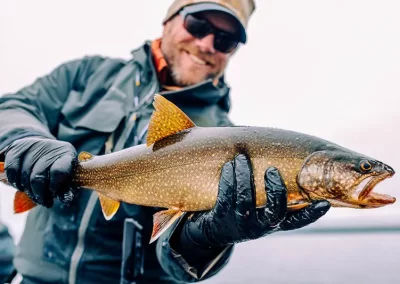 Jon Peterson showing off his catch on an early spring Sebago Lake Fishing trip