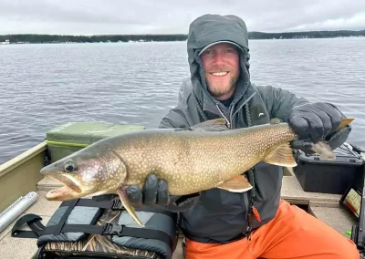 Jon Peterson showing off his catch on a spring Sebago Lake Fishing trip
